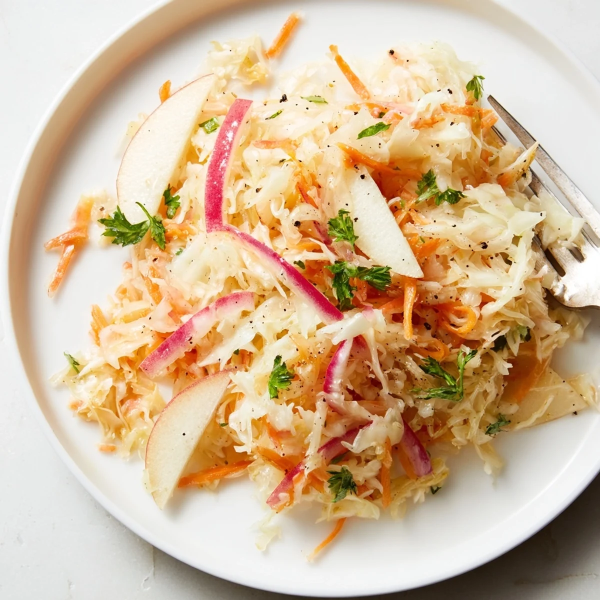 Crisp sauerkraut and apple slaw, featuring bright colors and fresh herbs.